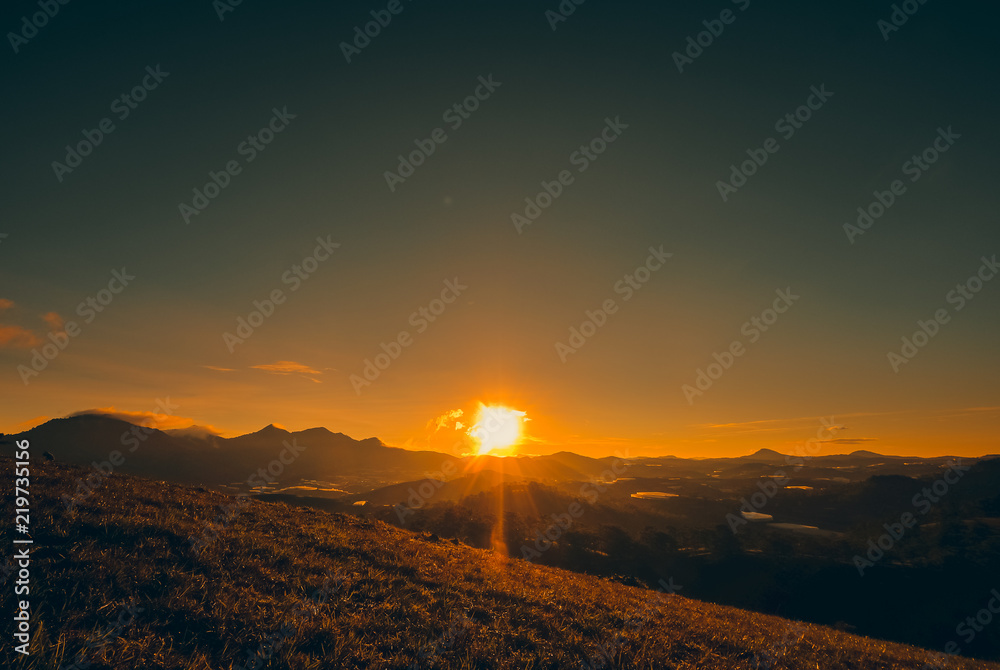 Silhouettes view beautiful sunrise on highland with mountain, nature background. Royalty high-quality free stock image of sunrise or sunset on the mountain. Amazing forrest hill landscape