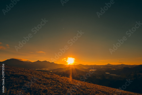 Silhouettes view beautiful sunrise on highland with mountain, nature background. Royalty high-quality free stock image of sunrise or sunset on the mountain. Amazing forrest hill landscape © jangnhut