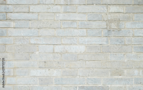 Old and dirty white brick wall for background texture.