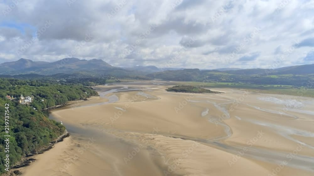 Aerial view, zoom out move. Drone panorama over low tide sea and sand. Landscape around Porthmeirion in Wales Aerial view, zoom out move. Drone panorama over low tide sea and sand. Landscape around Porthmeirion in Wales