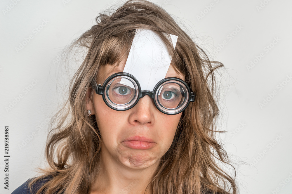 Funny woman with blank white sticky paper over her forehead Funny woman with blank white sticky paper over her forehead