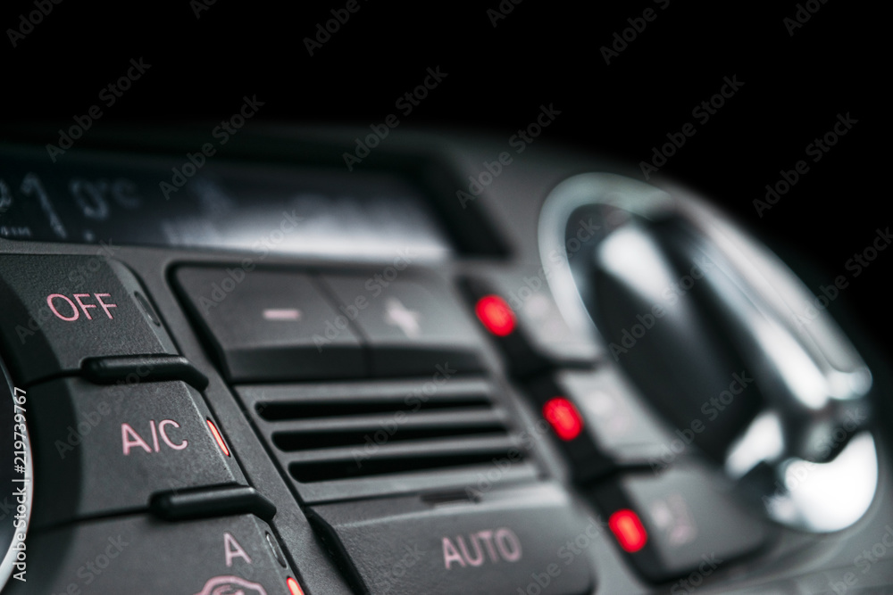 Air conditioning button inside a car. Climate control AC unit in the new car. Modern car interior details. Car detailing.