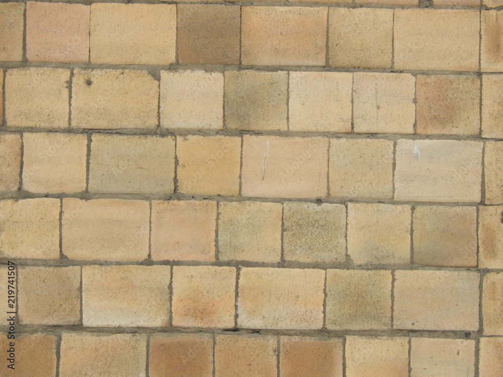 Wall of yellow stone blocks, background Wall of yellow stone blocks, background