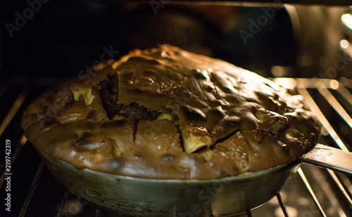 Dark homemade pie in the oven.