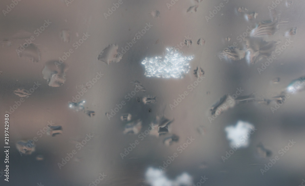 The snow melts on the windshield of the car. The snow melts on the windshield of the car.
