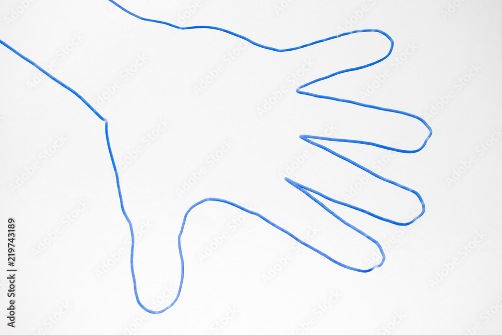 A contour of the human palm with a blue marker on a white background. A contour of the human palm with a blue marker on a white background.
