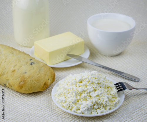A set of dairy products and bread on a light background.