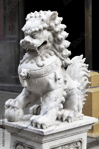Chinese lion at the entrance of a temple © Nadezhda Bolotina