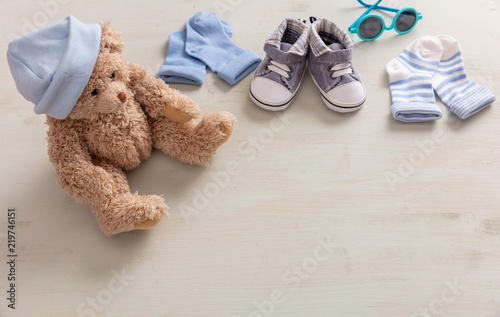 Baby boy shoes and socks on wooden background