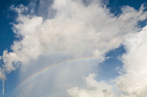 clear sky with clouds and rianbow,blue background © Anusorn