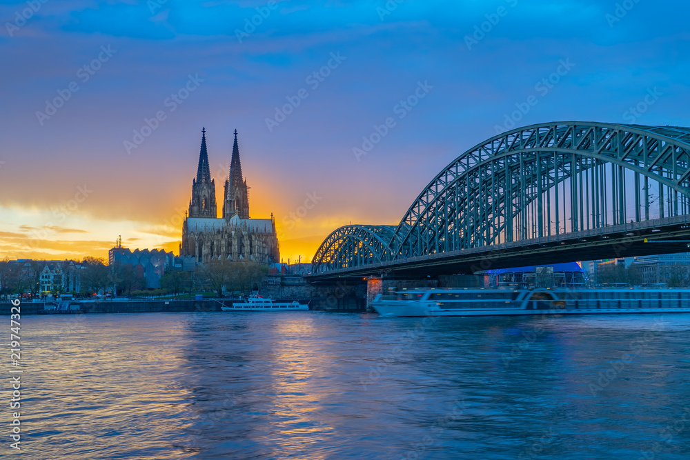 Hohenzollern Bridge with Cologne Cathedral at sunset in Cologne city, Germany