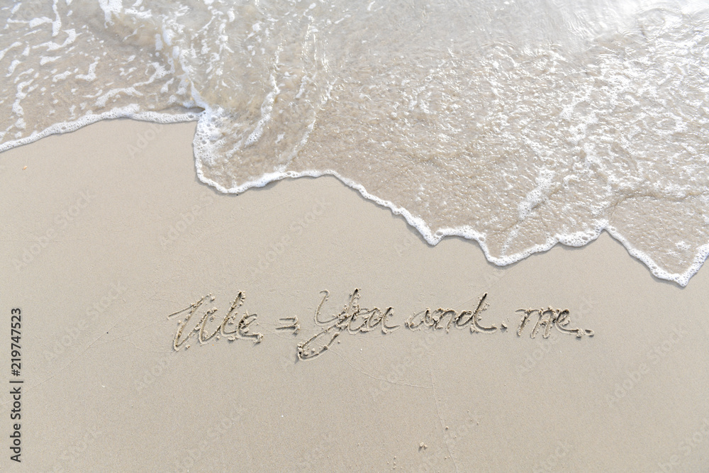 Fototapeta premium The text We and me written on the sand beach by the sea, Use it as a message is sent