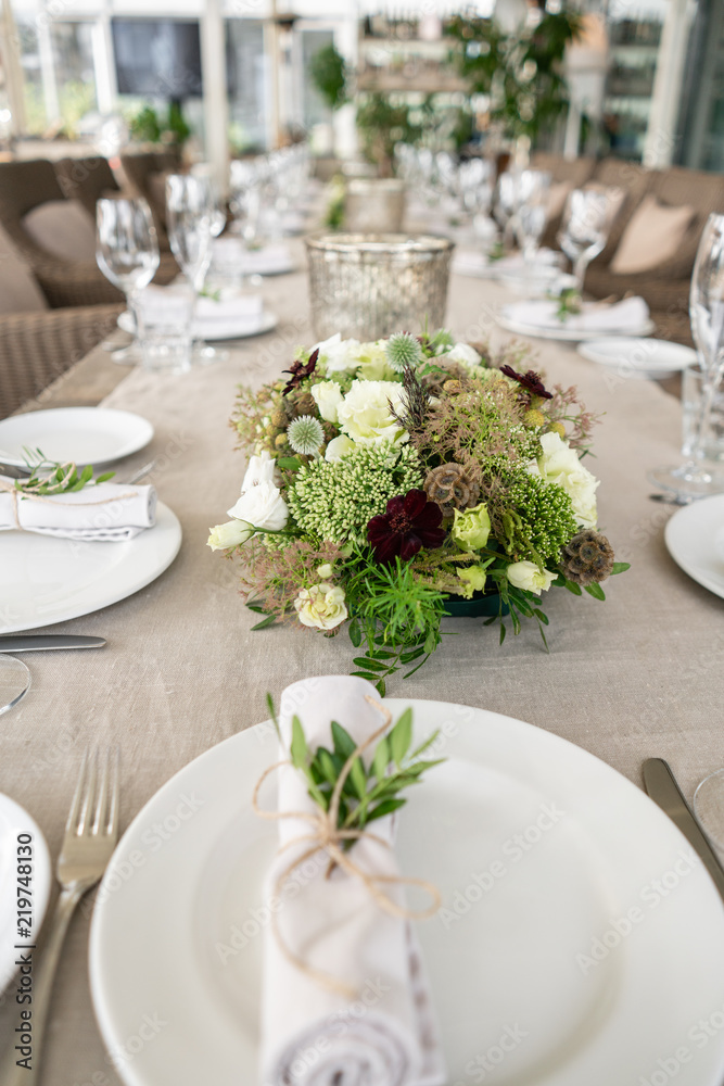 Wedding Banquet or gala dinner. The chairs and table for guests, served with cutlery and crockery. Covered with a linen tablecloth runner. party on terrace