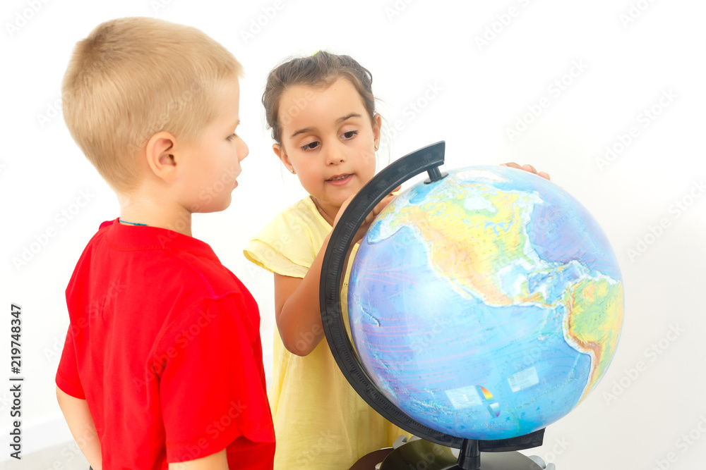 Two elementary school students looking at globe Two elementary school students looking at globe