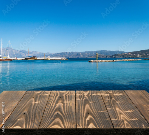 Wood table outside with seaview in beautiful summer day
