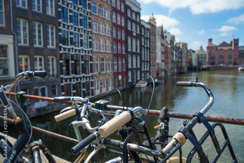 Fototapeta premium Bicycle over blurred canal of Amsterdam