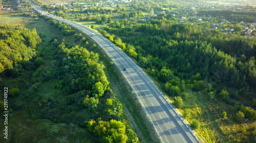road for cars aerial view from top around green nature © Chepko Danil