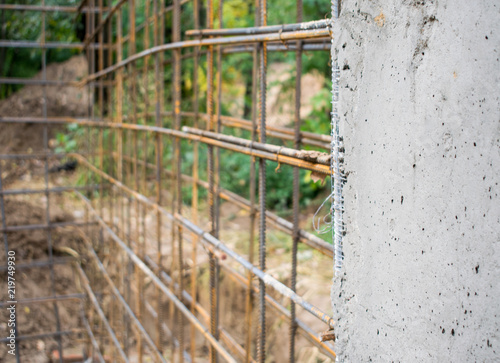 Linked steel reinforcement for the preparation of concrete pouring and part of the finished concrete wall.