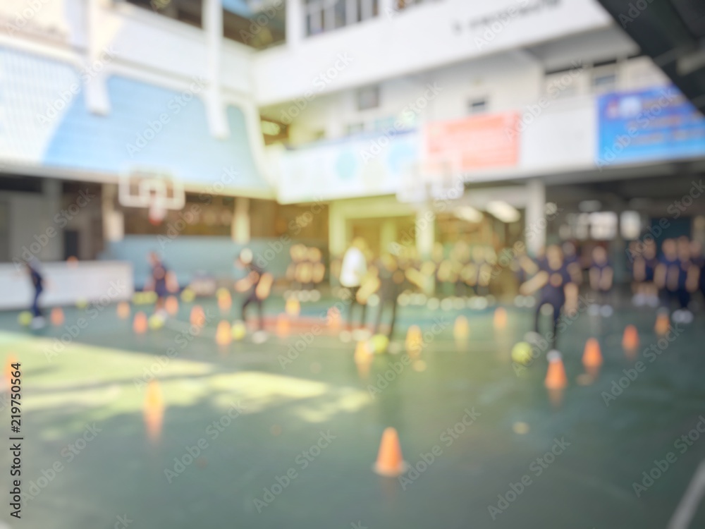 Obraz premium Blurred image of children or male and female students in secondary school are learning football or soccer on school playground in physical education time. Bangkok,Thailand. physical activities concept