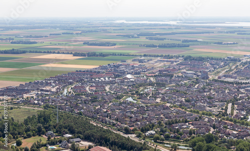 Aerial view Dutch village Urk with new build residential area in agricultural landscape © Kruwt