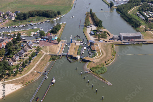 Aerial view Dutch village Stavoren with sluice, connection between lake IJsselmeer and canal Johan Frisokanaal