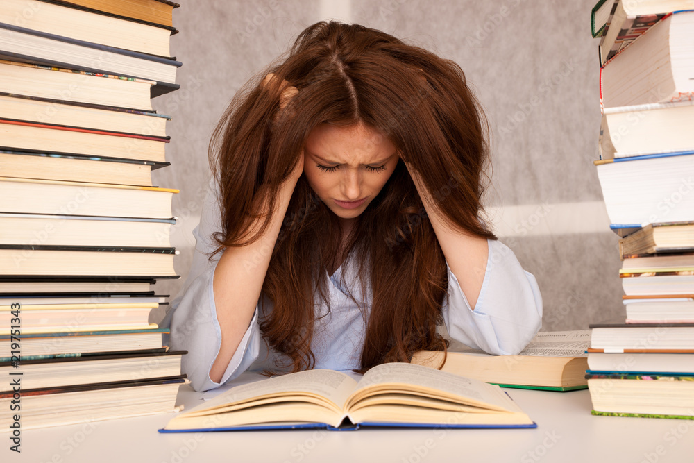attractive young woman student undre stress while studiing for exames attractive young woman student undre stress while studiing for exames