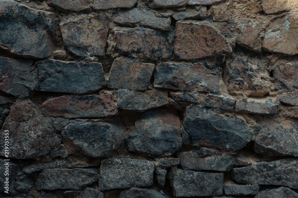 close-up view of dark grey stone wall texture