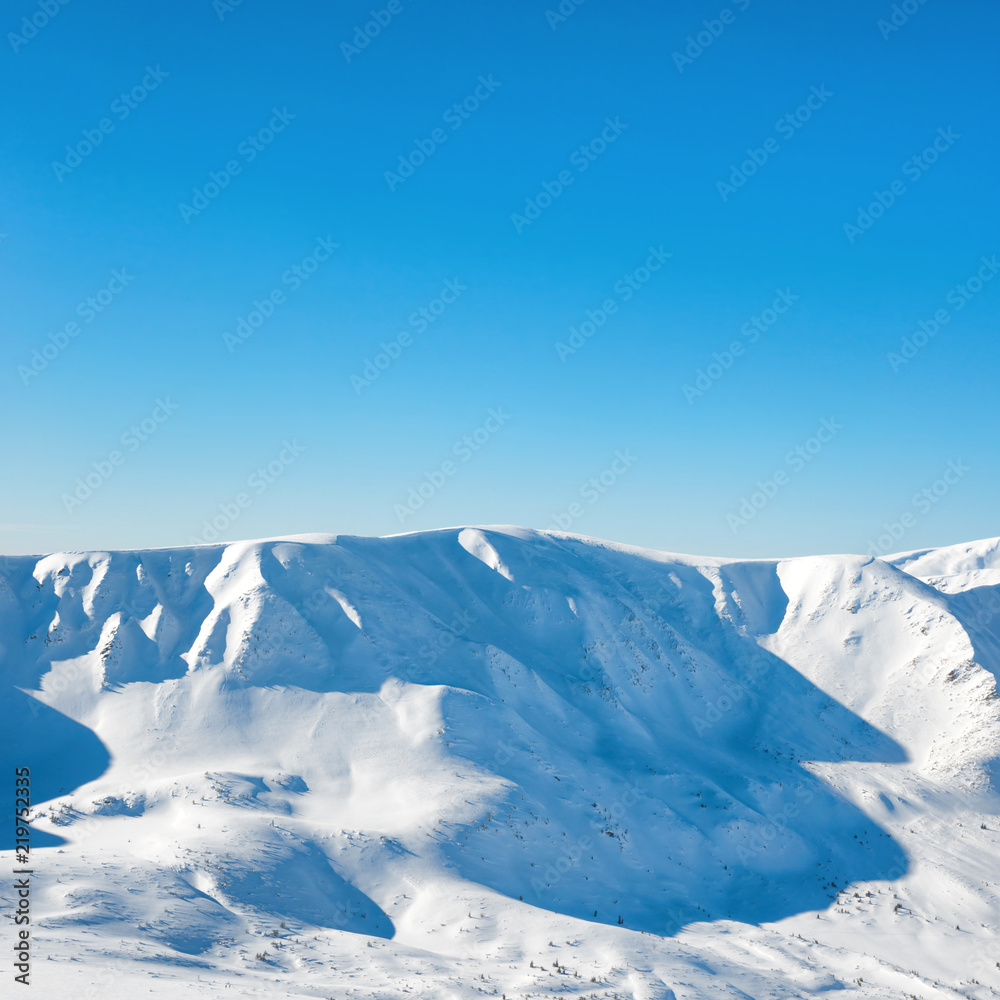 Range of mountains peaks in snow. Winter landscape