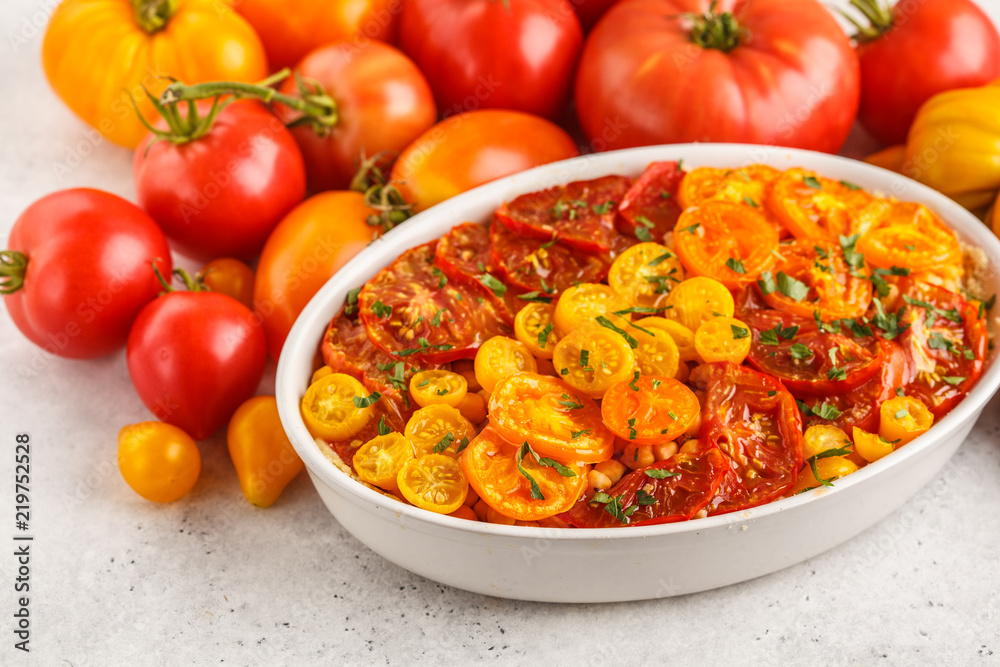 Tomato vegetarian pie with chickpeas and parsley in white dish. Tomato vegetarian pie with chickpeas and parsley in white dish.