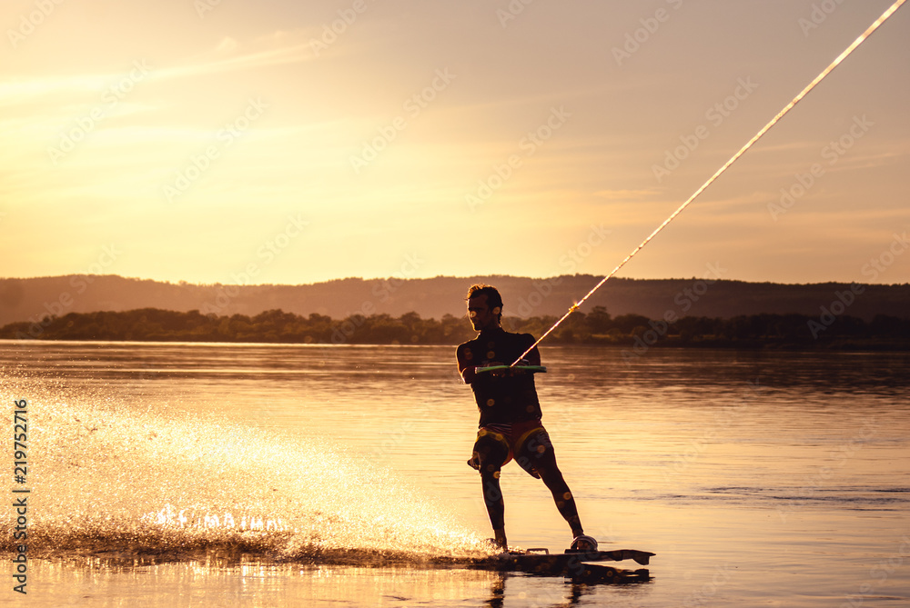 Wakeboarding. Athlete silhouette with splash of water