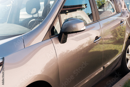 close-up view of shiny grey car parked on parking lot