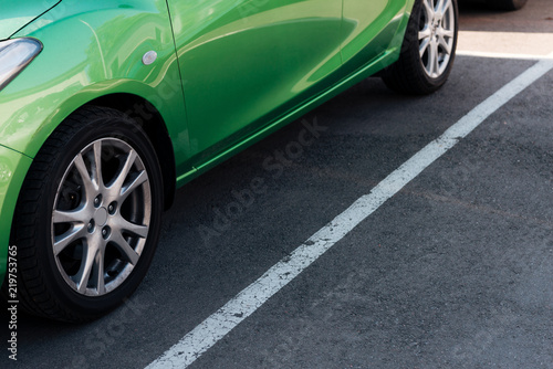 detail of green shiny car on parking lot © LIGHTFIELD STUDIOS