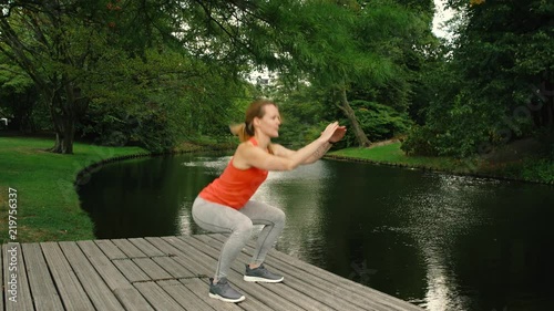 Young woman air squat, park, fintess, workout