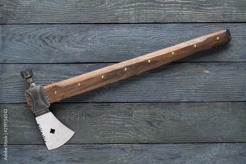 Tomahawk on a wood deck. Metal axe  on a wood surface