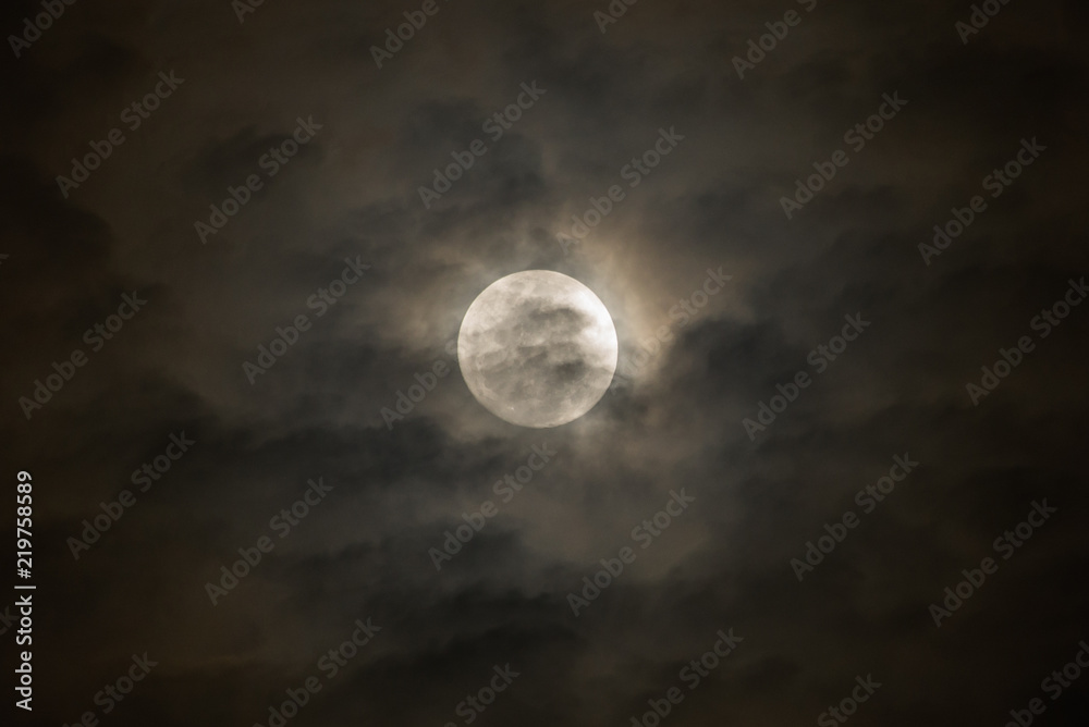 Dark cloud in the front of full moon