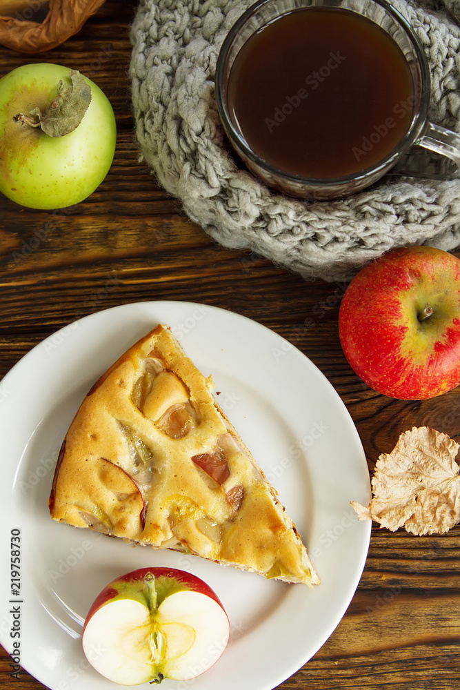 piec of an apple pie on a white plate on a wooden table piec of an apple pie on a white plate on a wooden table