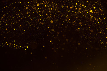 Glitter gold sparkling star dust falling shiny abstract bokeh background
