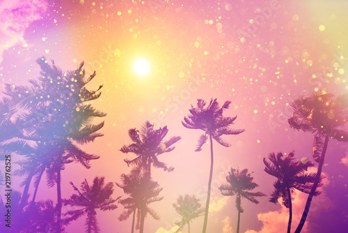 Fototapeta Naklejka Na Ścianę i Meble -  Tropical beach palms at sunset silhouettes party fairytale stylized with colofrul light leaks and gold glitter particles