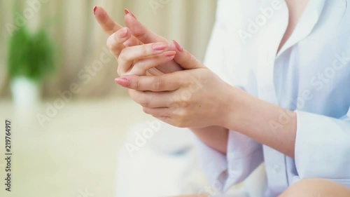 Wallpaper Mural beautiful model applying cosmetic cream treatment on her hand on bedroom background Torontodigital.ca