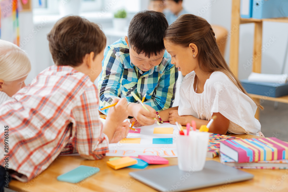 Talanted. Creative kids drawing while being in a classroom Talanted. Creative kids drawing while being in a classroom