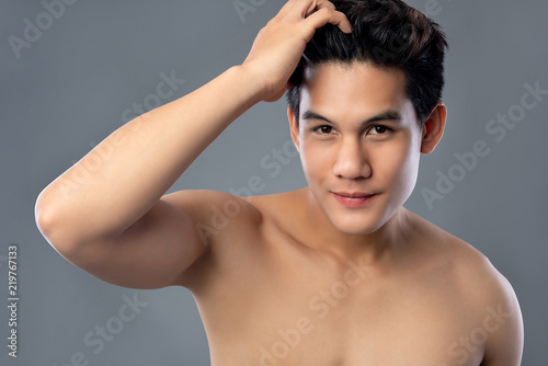 Shirtless young hamdsome Asian man with clean radiant face