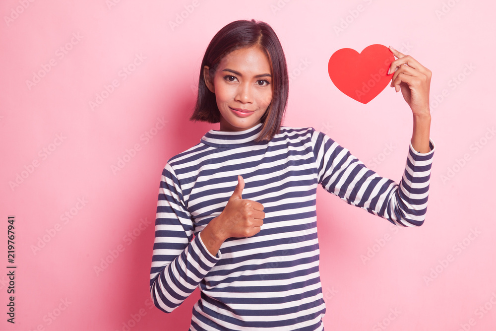 Asian woman thumbs up with red heart. Asian woman thumbs up with red heart.