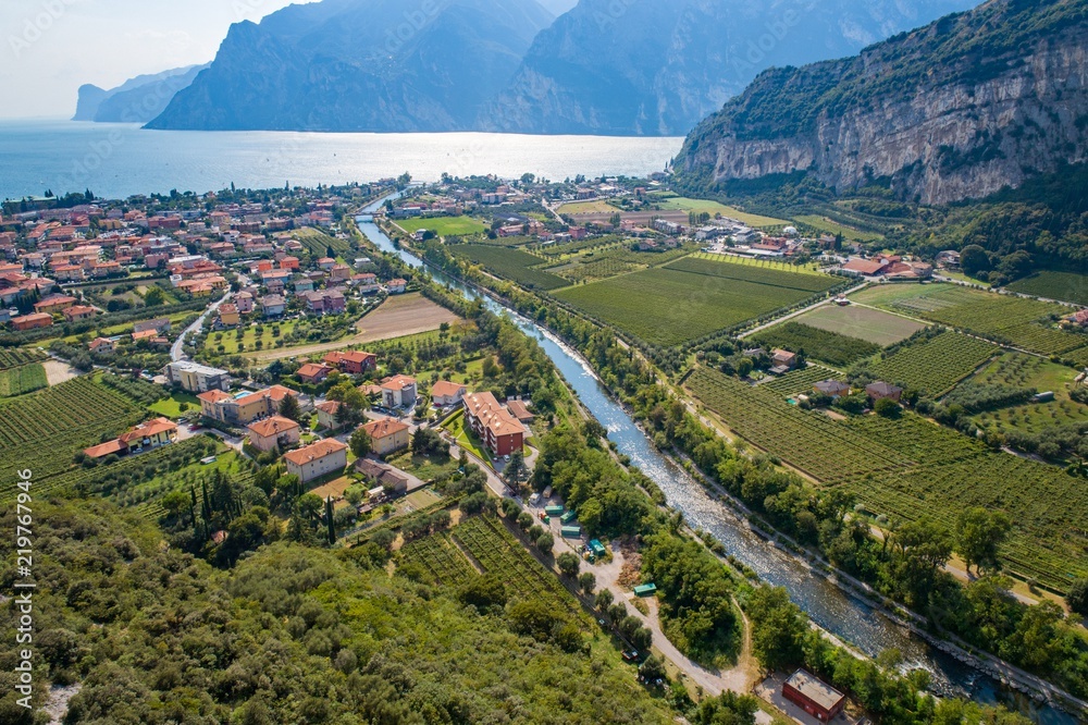 Aerial view on Nago Torbole city and Sarca River.