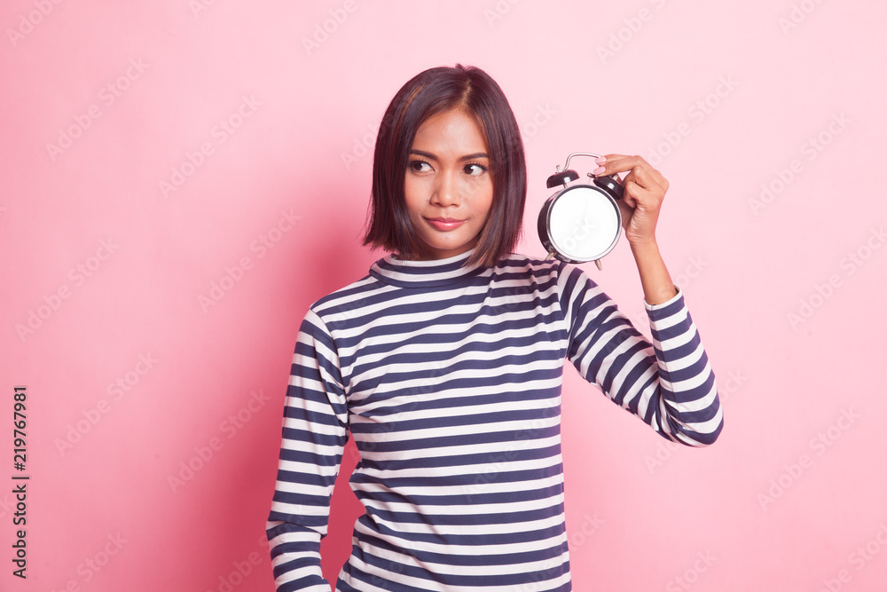 Fototapeta premium Young Asian woman with a clock.