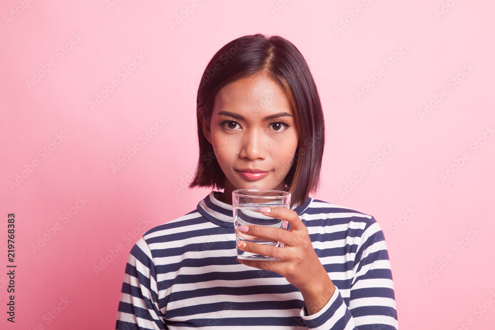 Young Asian woman with a glass of drinking water. Young Asian woman with a glass of drinking water.