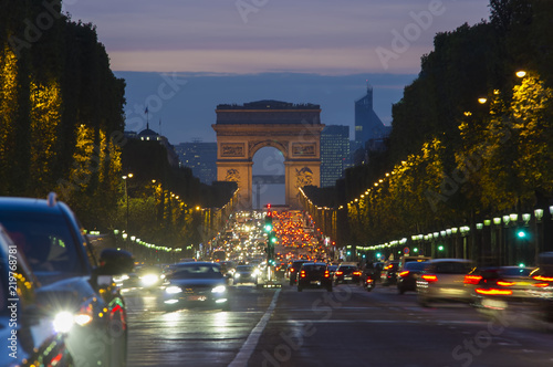 sunset scene in Paris city. Long exposure photo of street traffic near Arc de Triomphe, Champs Elysees boulevard. © Ioan Panaite