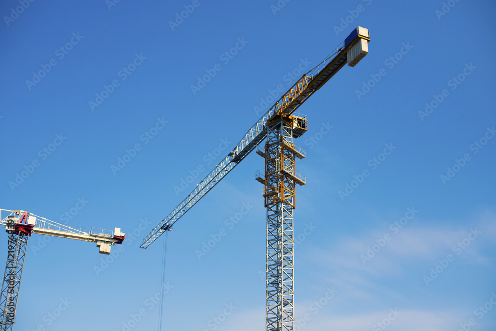Construction of a business center using a tower crane. Construction site and tower crane. Construction of a business center using a tower crane. Construction site and tower crane.