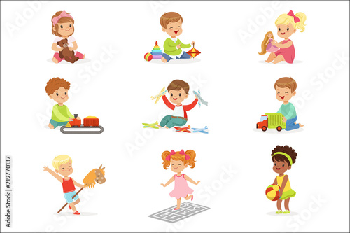 Cute Children Playing With Different Toys And Games Having Fun On Their Own Enjoying Childhood.