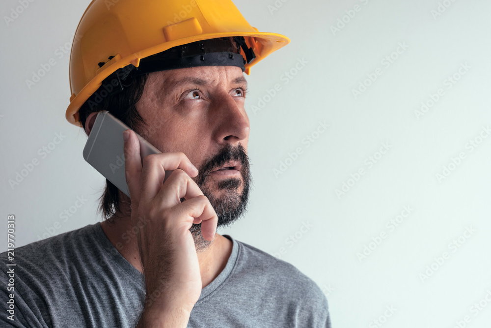 Construction engineer talking on mobile phone Construction engineer talking on mobile phone