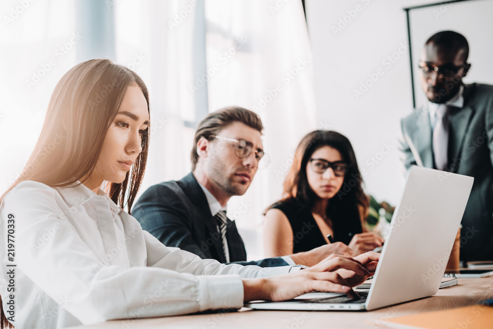 selective focus of multicultural business people having business meeting in office selective focus of multicultural business people having business meeting in office